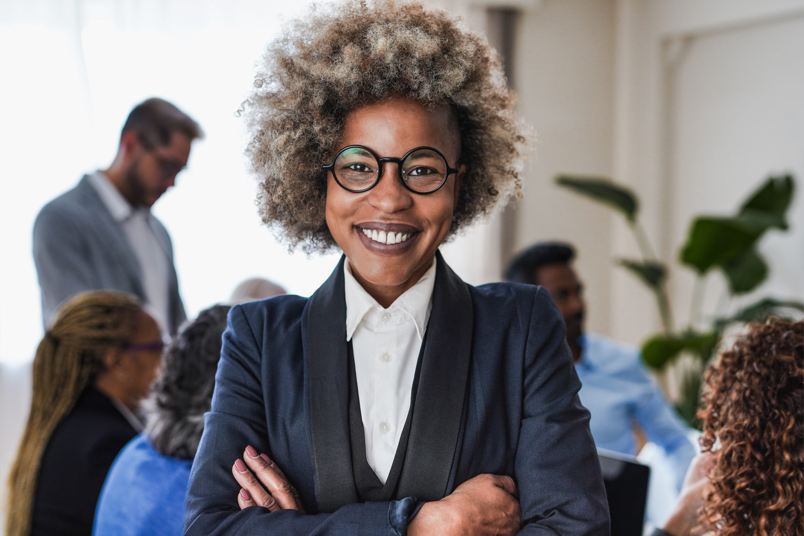 A leadership trainer for managers crossing their arms